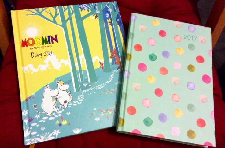 Two 2017 diaries - left, cover with Moomin and Snorkmaiden walking up a hill; right, polka dots on a green background